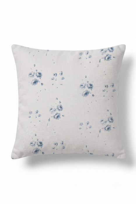 A square throw pillow in a light beige linen fabric with a blue shibori tie-dye floral pattern, shown against a plain white background.