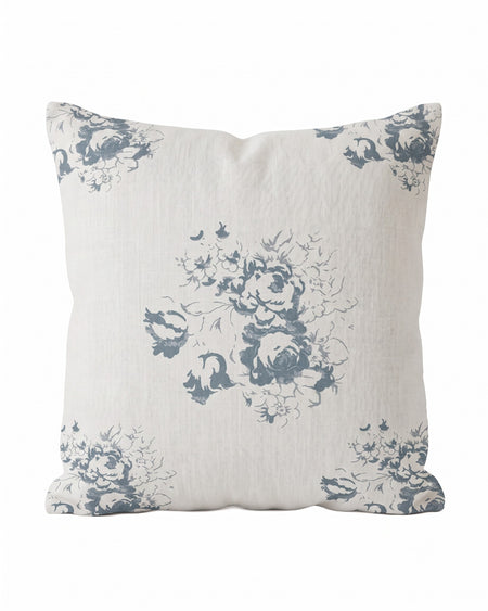 A square decorative throw pillow with a linen-textured off-white background and a muted blue-gray floral toile pattern, shown against a plain white background.