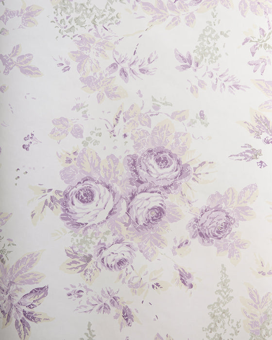 A close-up of floral wallpaper featuring a classic French toile pattern with lavender and light purple roses, wisteria, and leaves on a warm off-white background.
